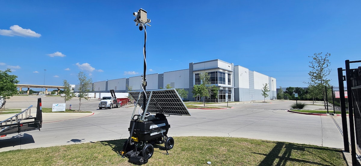 Solar-powered mobile surveillance camera outside warehouse